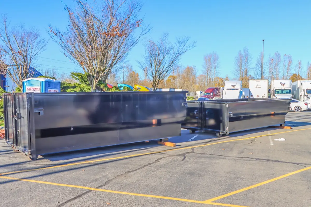 Professional dumpster rental service with roll-off container on residential driveway in Dumbarton